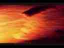 Catalog#:V01729 License:$35.00, Format:720x480 Indeo 4.5/5.1 (.AVI) at 30fps, Length:9 sec. Orange-red backlit stratus wave, zoom timelapse